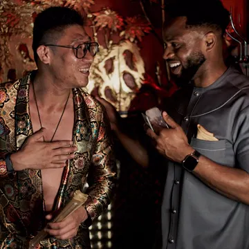 Two XChange Models makers laughing over a phone