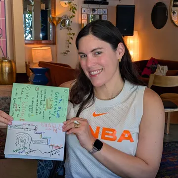 A Zine Machine member holding up the zine she made