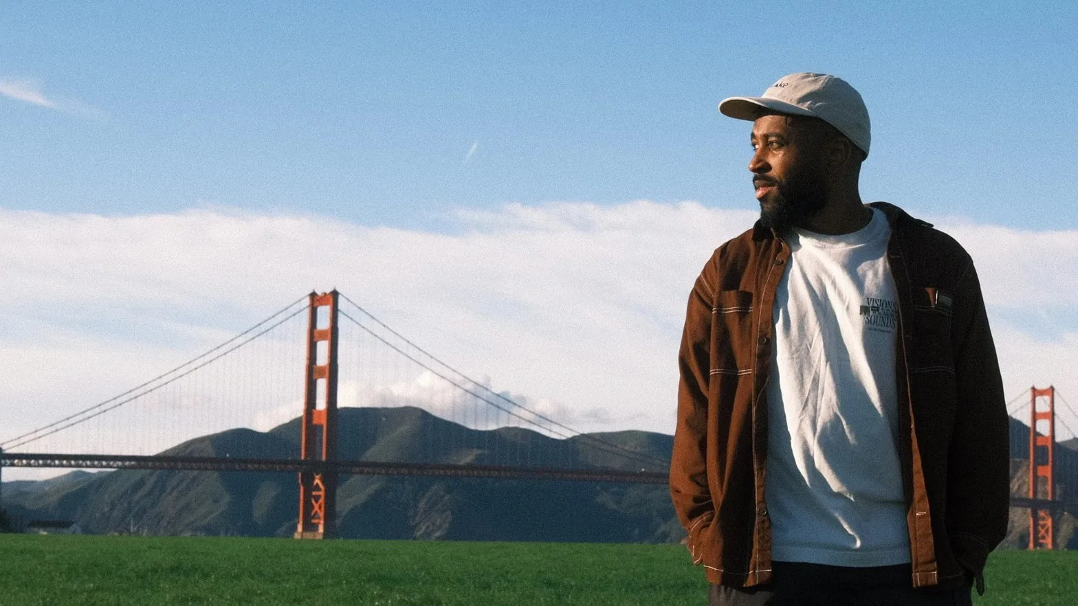 Uko in brown jacket with Golden Gate Bridge behind