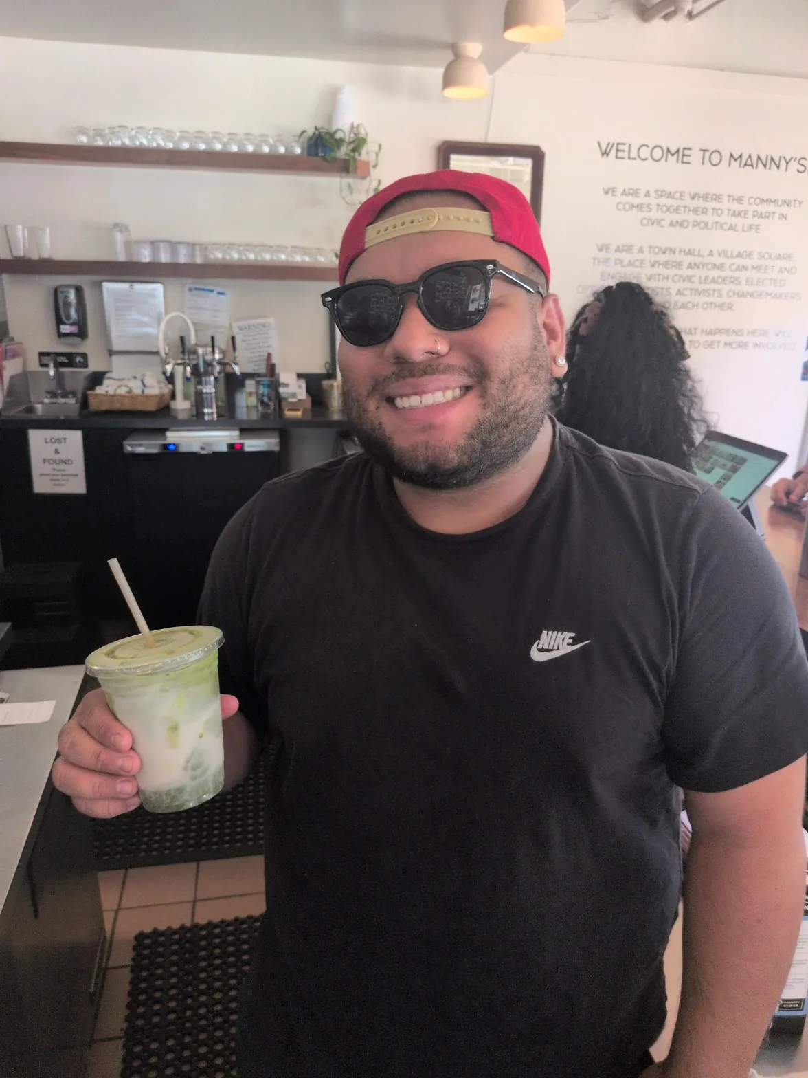 Mauricio smiling with matcha latte