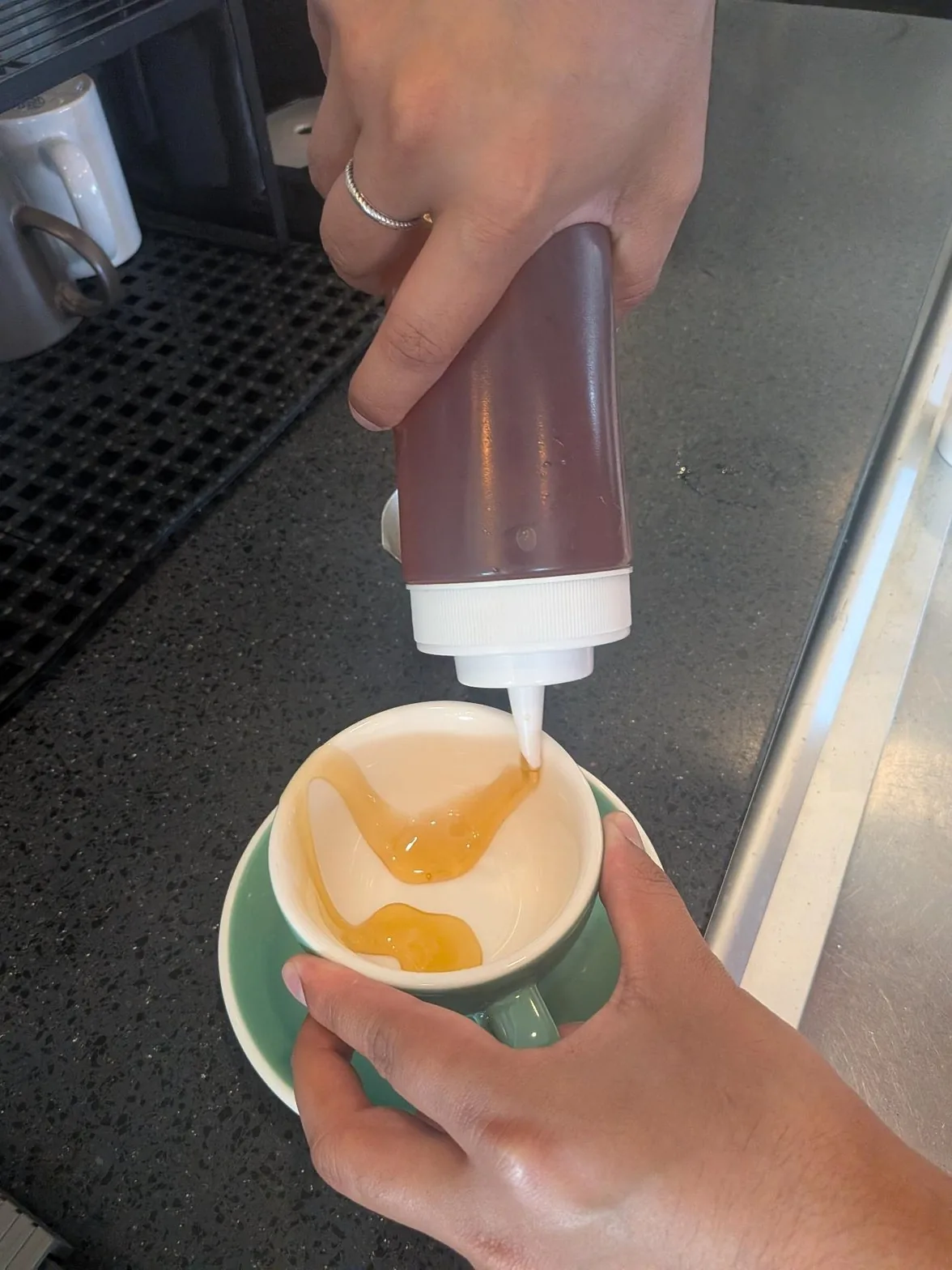 Honey poured onto cappuccino rim